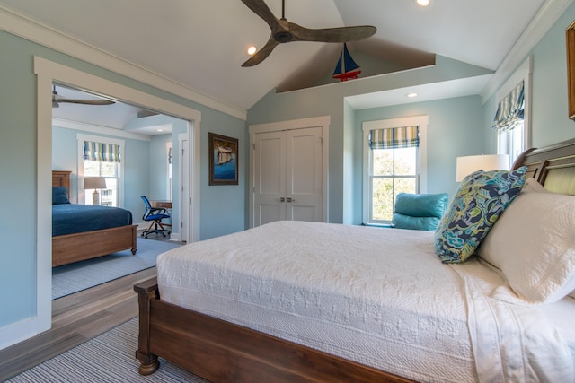 bedroom with lofted ceiling, a closet, dark wood finished floors, and recessed lighting