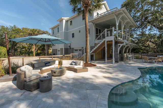 rear view of house featuring a fenced in pool, board and batten siding, a patio area, an outdoor living space, and stairs