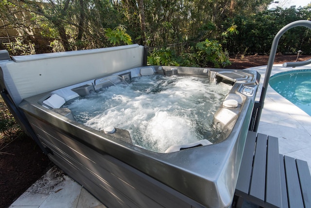 view of pool with a hot tub