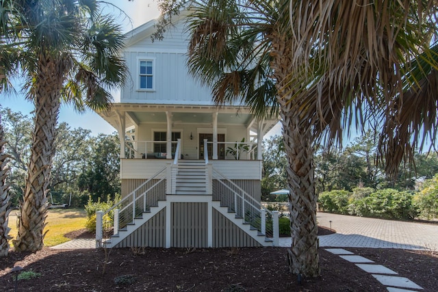 beach home with covered porch and stairway