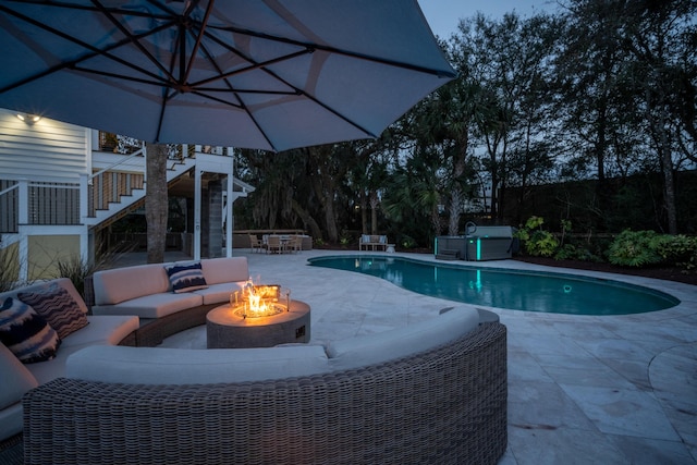 pool featuring stairs, a patio area, and an outdoor living space with a fire pit