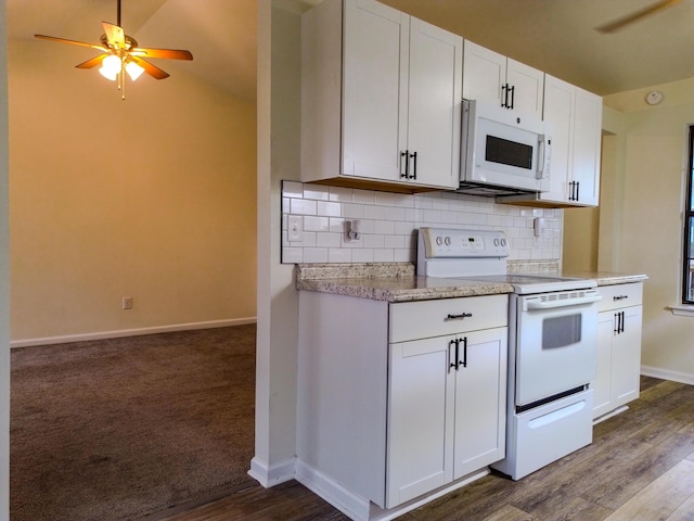 kitchen with white appliances, ceiling fan, wood-type flooring, white cabinets, and decorative backsplash