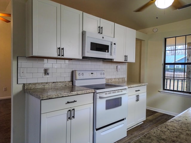 kitchen with white appliances, ceiling fan, white cabinetry, dark hardwood / wood-style floors, and decorative backsplash