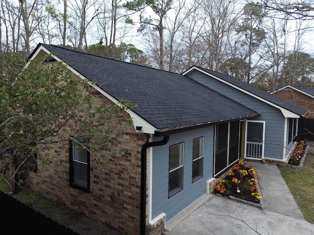 view of side of property featuring a sunroom