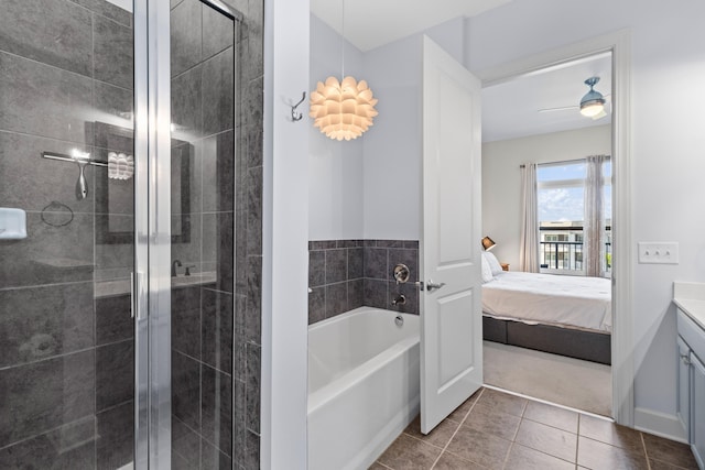 ensuite bathroom with ensuite bathroom, tile patterned flooring, vanity, and a shower stall