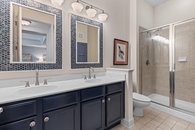 full bath featuring tile patterned floors, a shower stall, and a sink