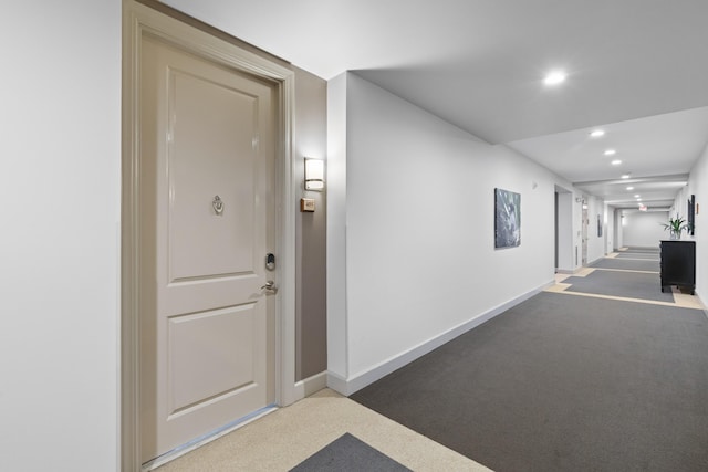 corridor featuring carpet flooring, recessed lighting, and baseboards