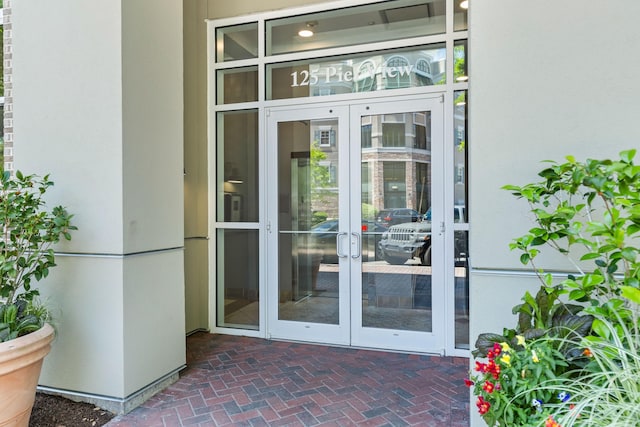 property entrance featuring french doors and stucco siding