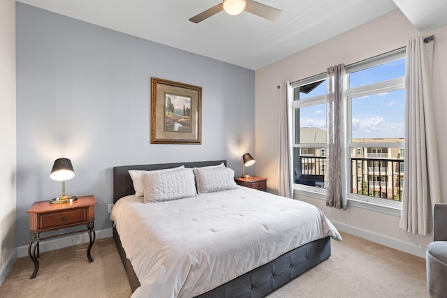 bedroom with baseboards, a ceiling fan, and light carpet