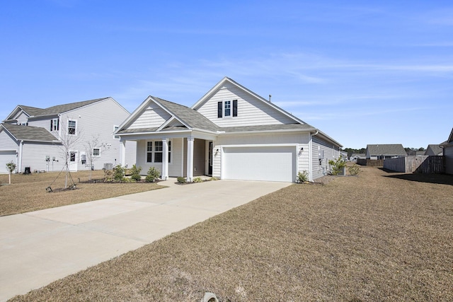 view of front of house featuring concrete driveway, an attached garage, and fence