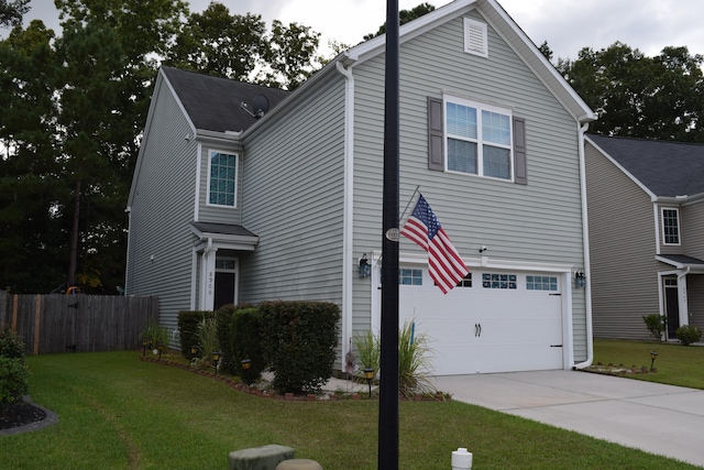 view of front of home with a front yard and a garage