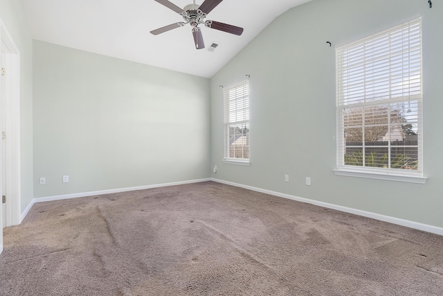 carpeted empty room featuring baseboards, a ceiling fan, and vaulted ceiling