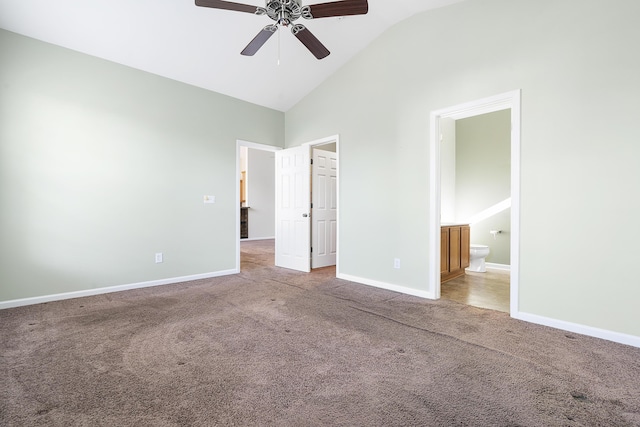 unfurnished bedroom with a ceiling fan, baseboards, high vaulted ceiling, carpet flooring, and connected bathroom