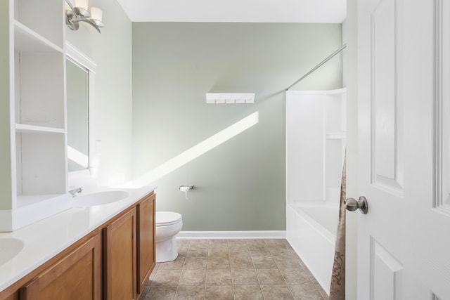 full bathroom with toilet, vanity,  shower combination, and baseboards