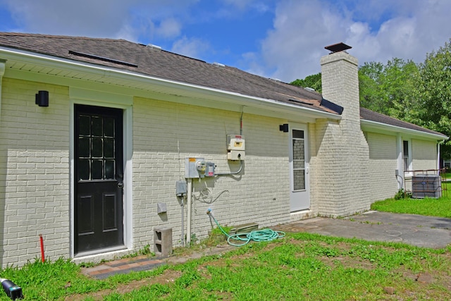 1101 Stuart Dr, Moncks Corner, SC 29461 - back of house with brick siding, a chimney, and roof with shingles