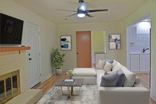 1101 Stuart Dr, Moncks Corner, SC 29461 - living room with wood finished floors, ceiling fan, a fireplace, and baseboards