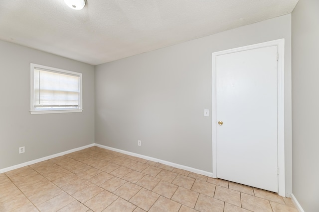 unfurnished room with a textured ceiling