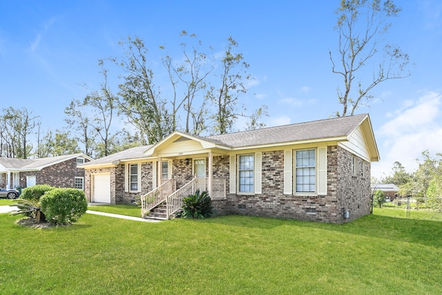 ranch-style house featuring a front yard, a garage, and covered porch