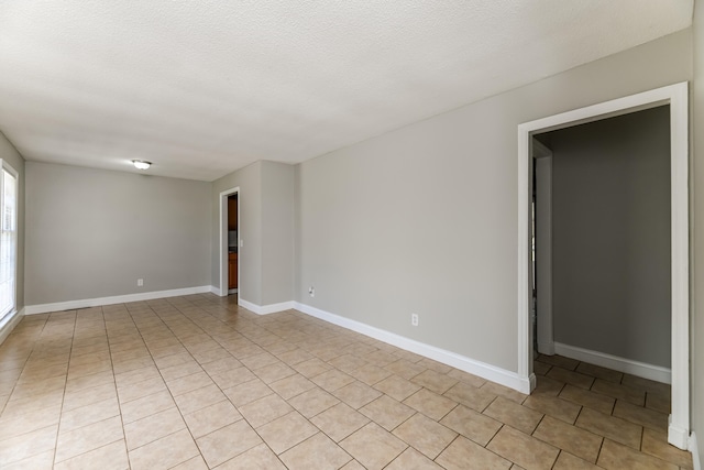 unfurnished room with a textured ceiling