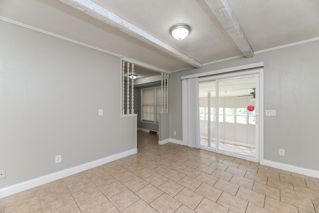 empty room featuring beam ceiling and a textured ceiling