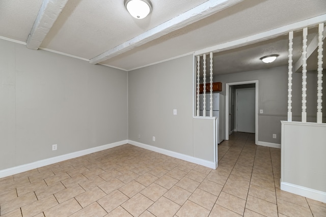 spare room with a textured ceiling and beam ceiling