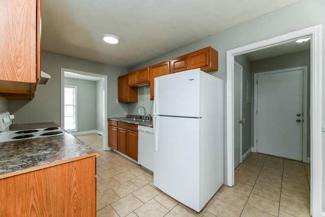 kitchen featuring ventilation hood, white appliances, sink, and a textured ceiling