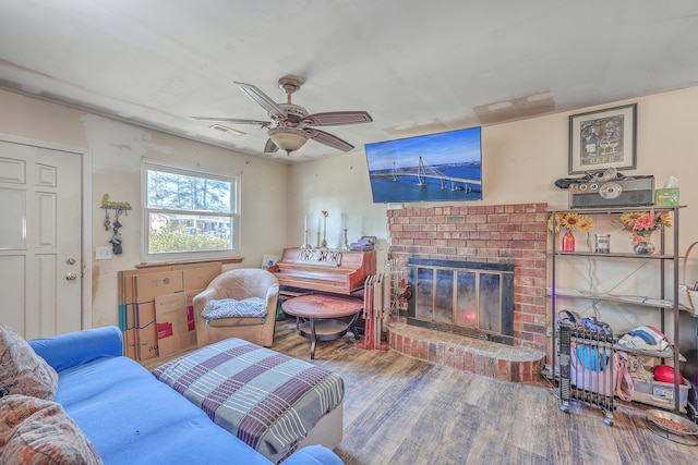 living room with ceiling fan, hardwood / wood-style floors, and a fireplace