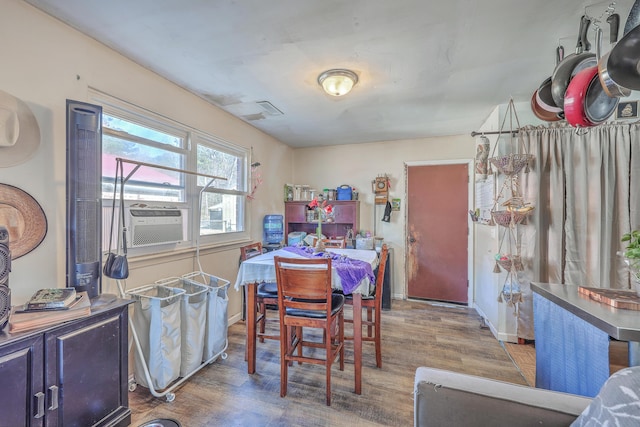 dining space featuring dark hardwood / wood-style flooring and cooling unit