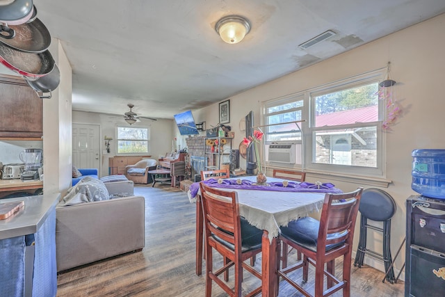 dining area featuring cooling unit, dark hardwood / wood-style floors, and ceiling fan