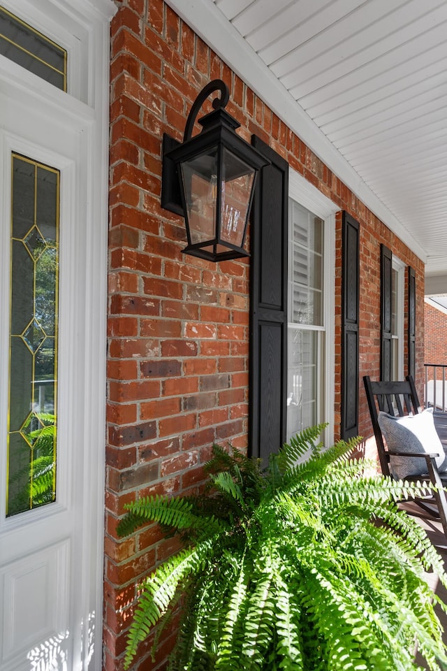 exterior space featuring a porch and brick siding