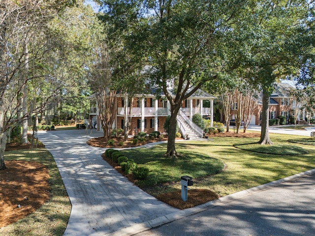 view of front of home with a residential view, brick siding, and a front yard