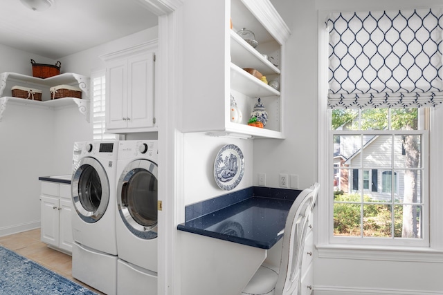 washroom with cabinet space and independent washer and dryer