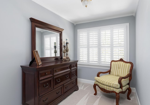 sitting room with light colored carpet, baseboards, and ornamental molding