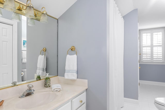 full bathroom with baseboards, toilet, vanity, and tile patterned flooring