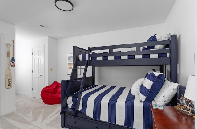 carpeted bedroom featuring baseboards and visible vents