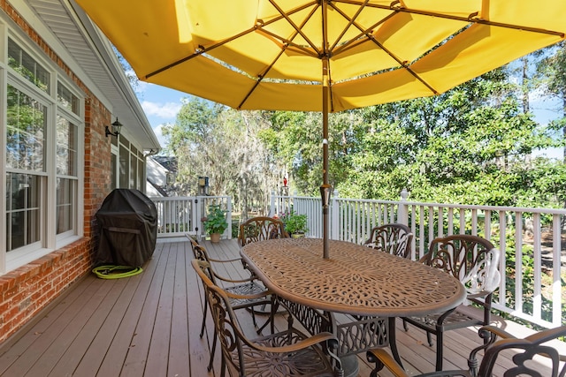 wooden terrace with area for grilling and outdoor dining area