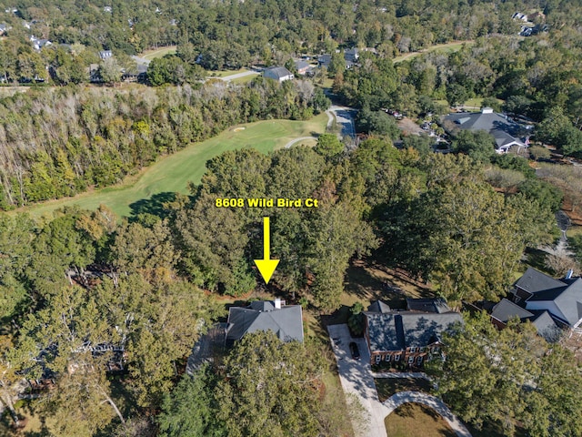 drone / aerial view with a wooded view