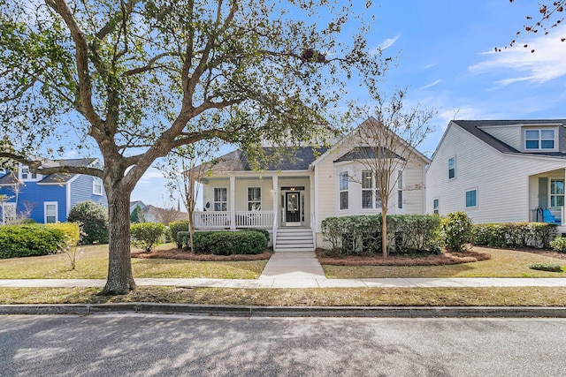 view of front of home with covered porch and a front lawn