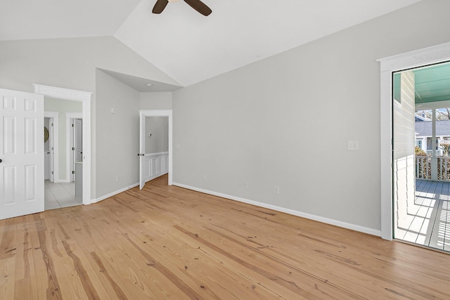 interior space with access to exterior, lofted ceiling, light wood-style floors, ceiling fan, and baseboards