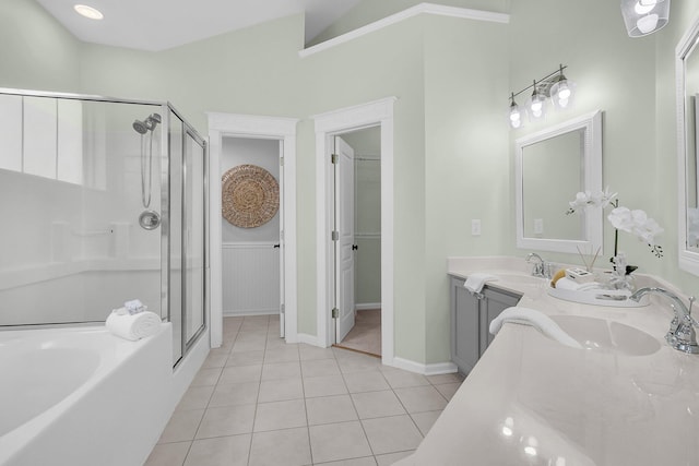 full bathroom featuring double vanity, a sink, a shower stall, and tile patterned floors