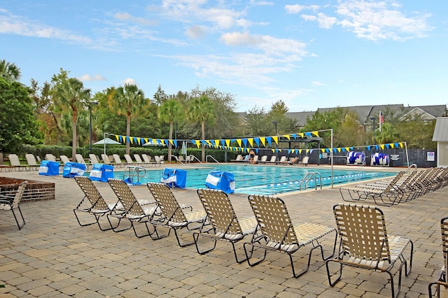 community pool featuring a patio area and fence