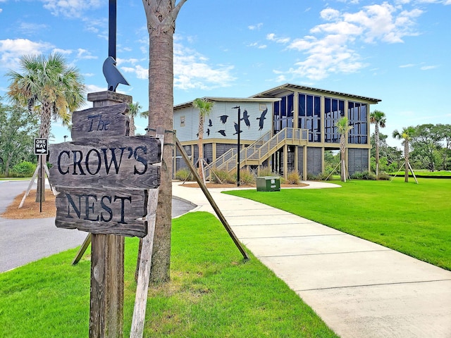 exterior space featuring stairs and a lawn