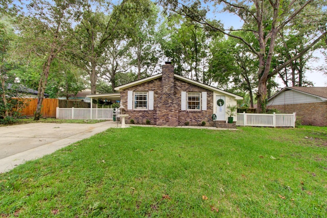 10 Teaneck Rd, Goose Creek, SC 29445 - view of front facade with a chimney, brick siding, driveway, and an attached carport