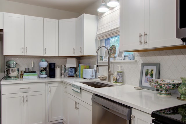 10 Teaneck Rd, Goose Creek, SC 29445 - kitchen with stainless steel appliances, light countertops, white cabinetry, and decorative backsplash