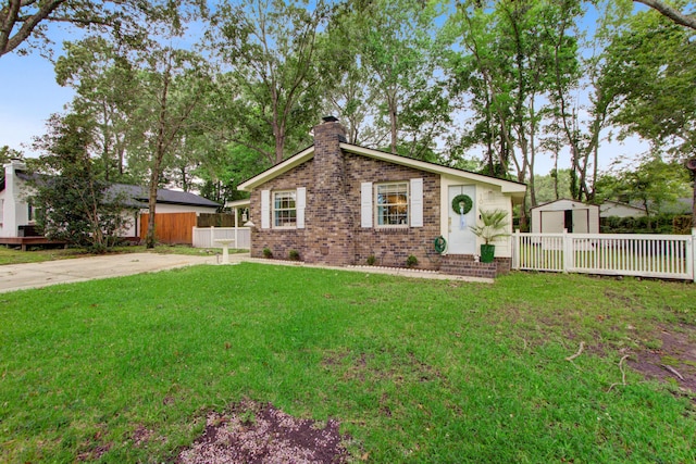10 Teaneck Rd, Goose Creek, SC 29445 - view of front of property with a chimney, a shed, and brick siding