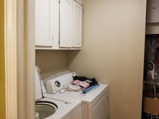 laundry room with cabinets and washing machine and clothes dryer