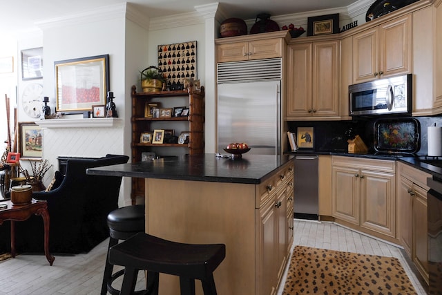 kitchen with decorative backsplash, appliances with stainless steel finishes, a kitchen island, and a kitchen breakfast bar