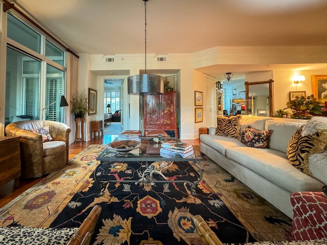 living room featuring hardwood / wood-style floors and crown molding