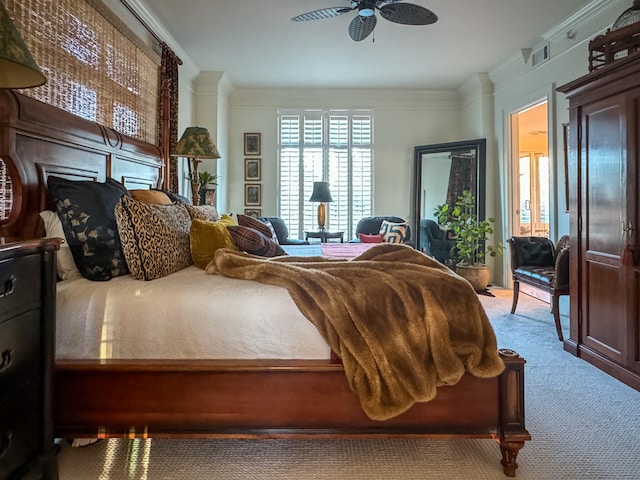 carpeted bedroom featuring ceiling fan and ornamental molding