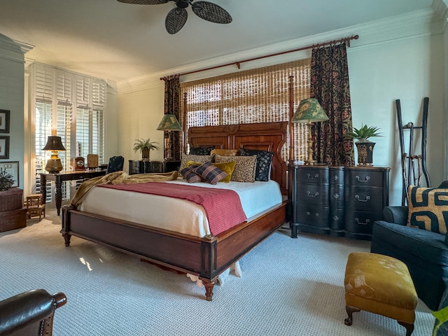 carpeted bedroom featuring ceiling fan and ornamental molding